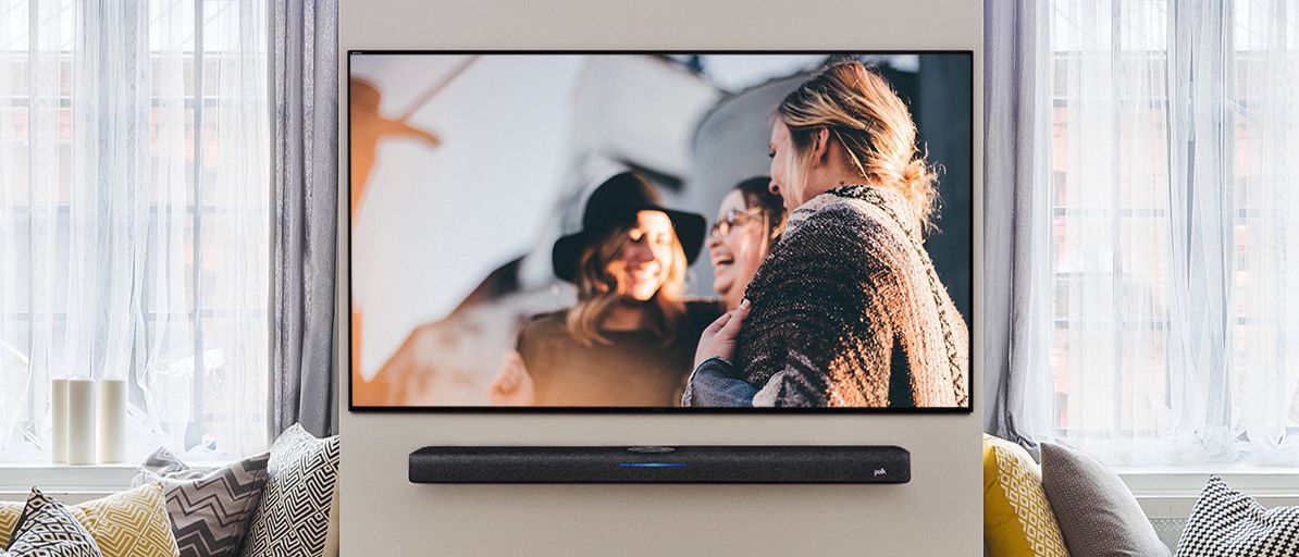 the polk react soundbar mounted beneath a tv