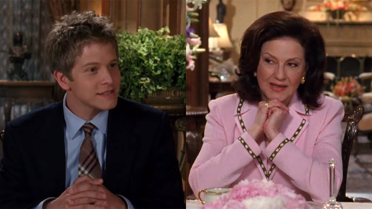 Emily Gilmore and Logan Huntzberger sitting at the dining room table with their hands folded.