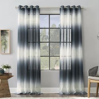Atlantic Ombre Curtain Panel against a gray wall.