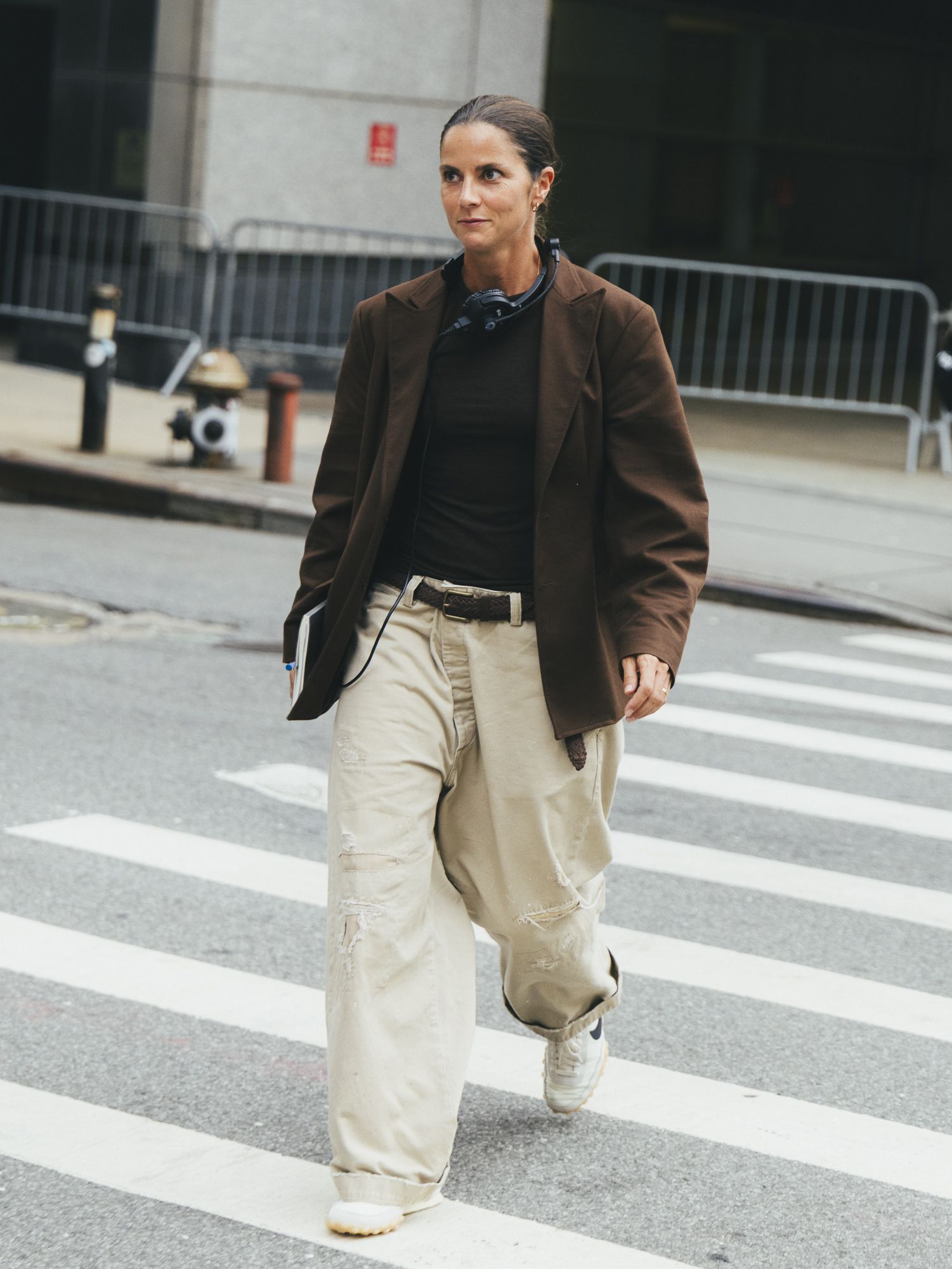 woman wearing brown suede jacket and cream pants