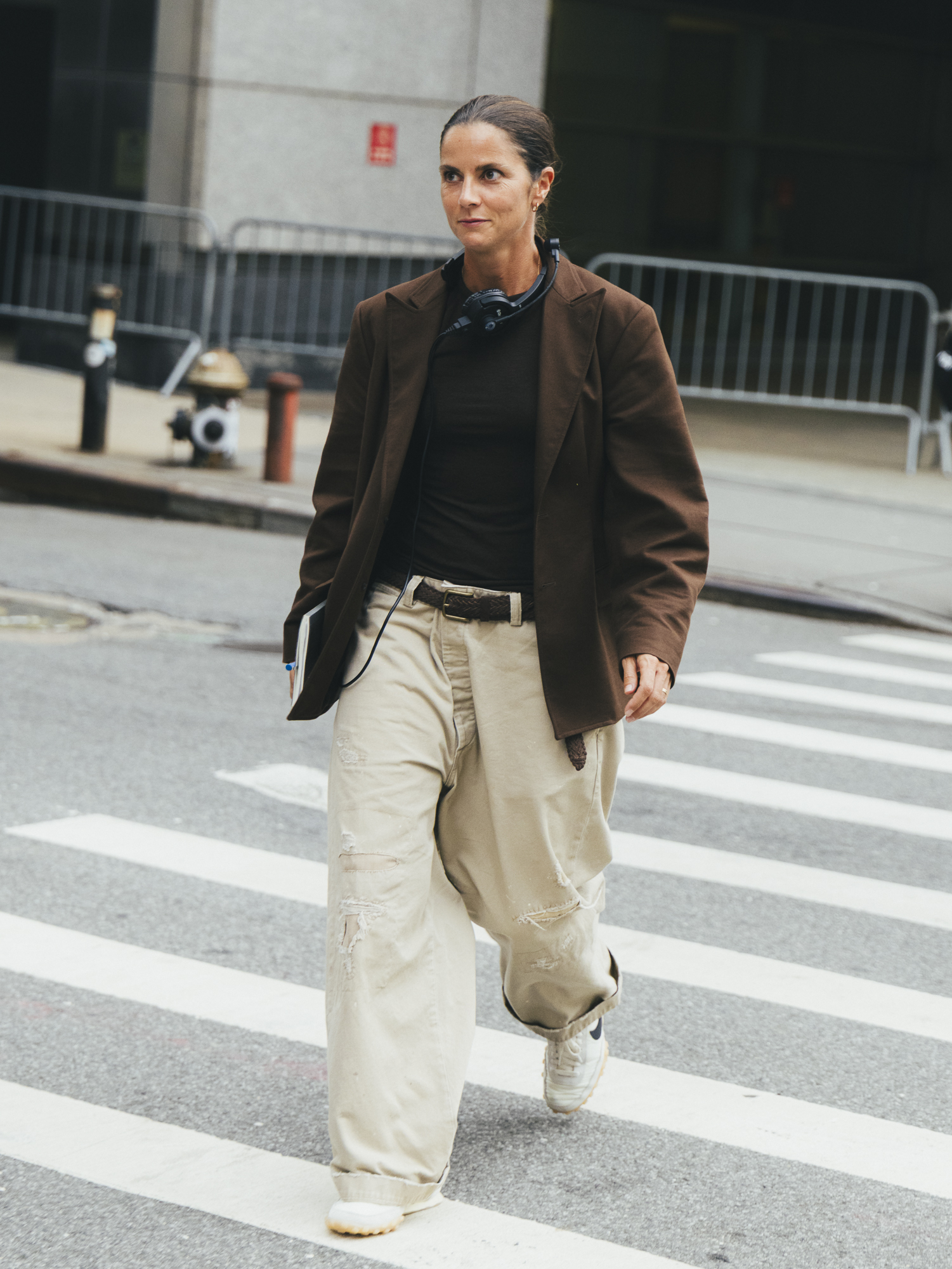 woman wearing brown suede jacket and cream pants