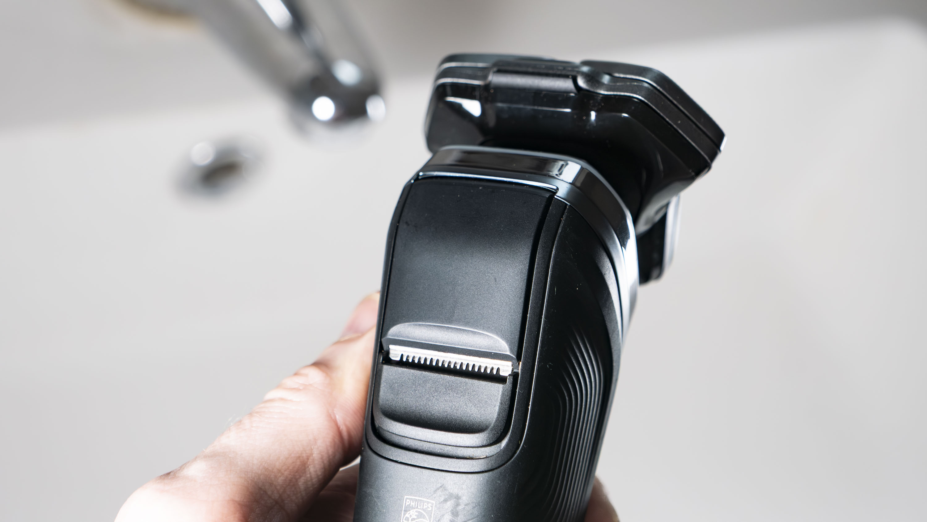 Close up of the Philips i9000 electric razor's pop-up trimmer