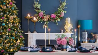 Christmas tree in a blue dining room with natural flowers to show how to decorate a Christmas tree with foliage