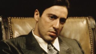 Al Pacino sits as Michael Corleone in The Godfather