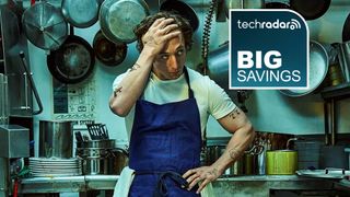 Carmy from The Bear looking stressed in a kitchen, with a deals logo stating 'big savings' next to him.
