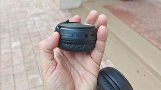 Anker Soundcore H30i held in hand showing controls