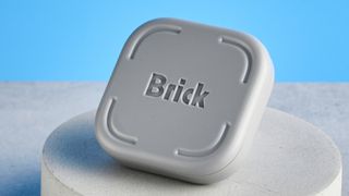 The Brick gadget photographed in front of a blue background