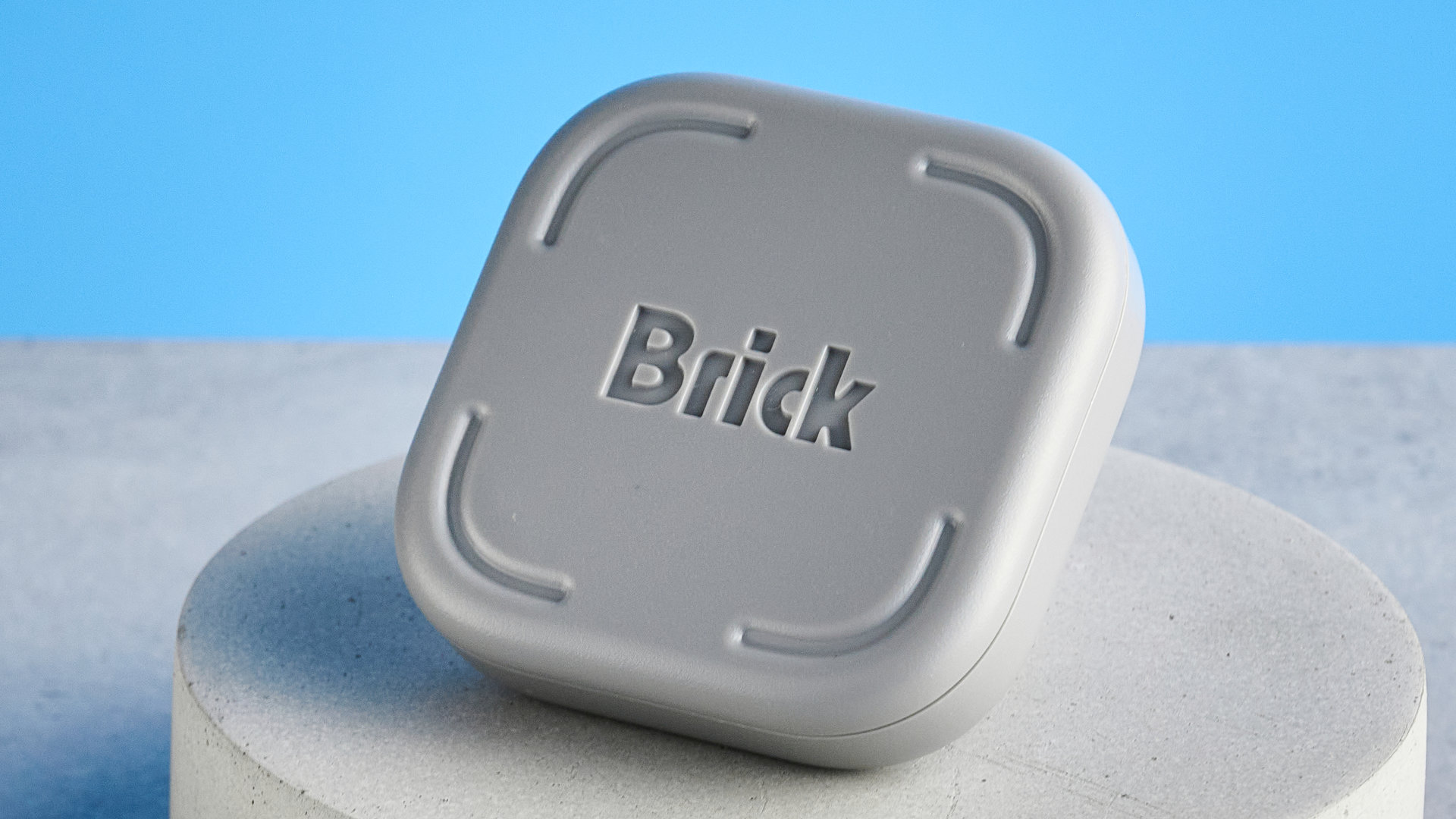 The Brick gadget photographed in front of a blue background