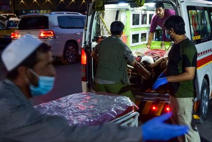 Medical staff bring injured man to a hospital in Kabul