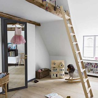 double height room kids bedroom with toys creating second bedroom at the top of the ladder