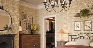 Cottagecore bedroom with wallpaper and black iron furniture and fittings