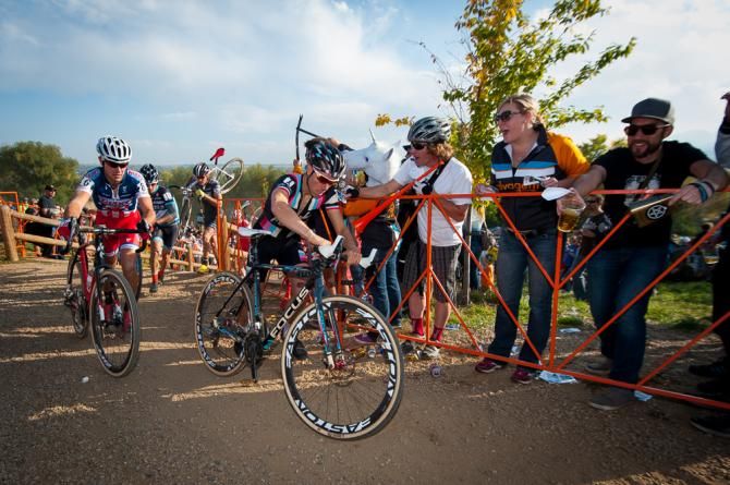 Jermey Powers (Rapha Focus) and Yannick Eckmann (California Giant) getting ready to remount thier bikes as fans enjoy the race moments. Boulder Cup.