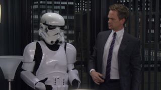 Neil Patrick Harris as Barney Stinson next to his Stormtrooper armor on How I Met Your Mother
