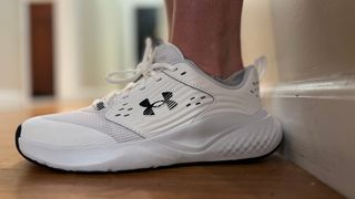 white under armour commit 4 worn by writer jessica rizzuto; just feet and shoes showing