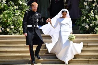 In this file photo taken on May 19, 2018, Britain's Prince Harry, Duke of Sussex and his wife Meghan, Duchess of Sussex emerge from the West Door of St George's Chapel, Windsor Castle, in Windsor, after their wedding ceremony.