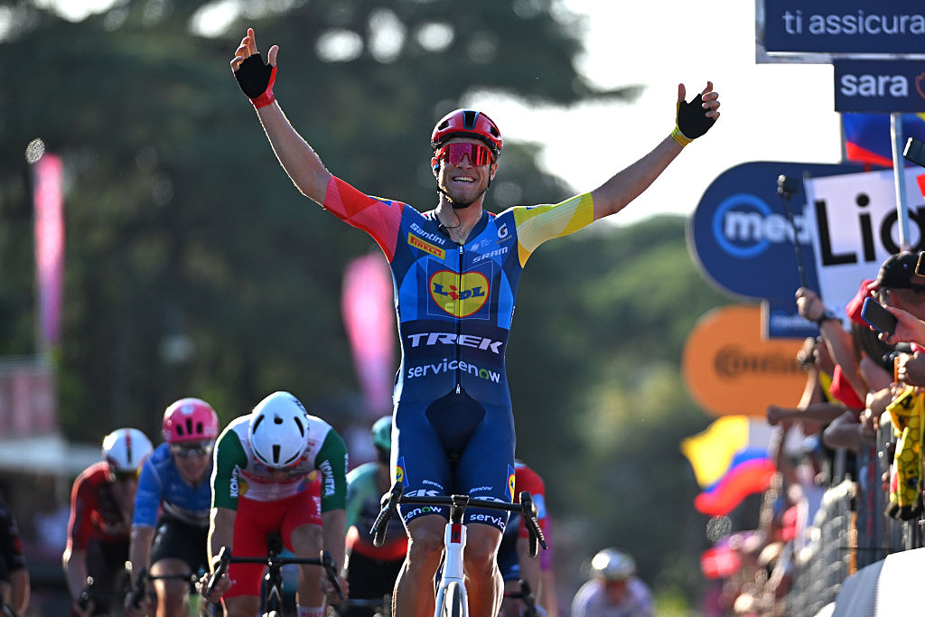 Milan celebrating in front of the peloton