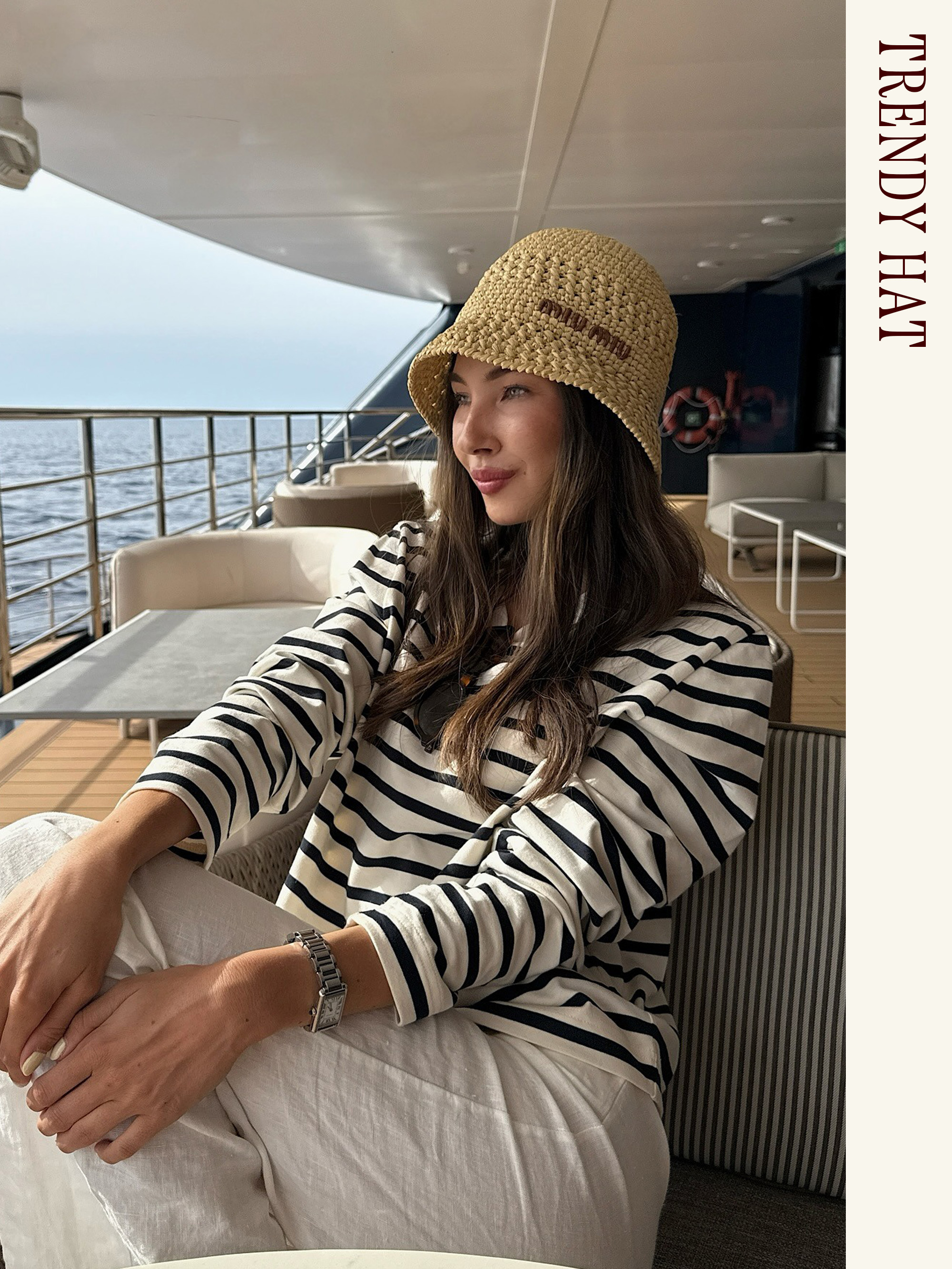 Influencer wearing a Miu Miu raffia bucket hat with a striped shirt and white pants