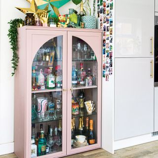 room with drinks under pink cabinet