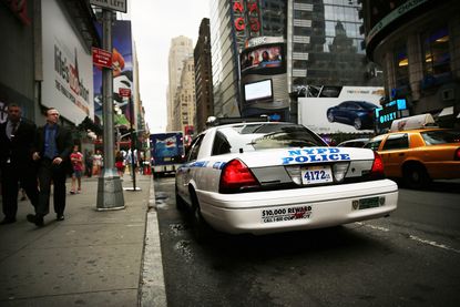 An NYPD car parked in Times Square.