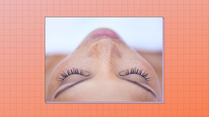 close up of woman lying down showing her lashes with mascara on