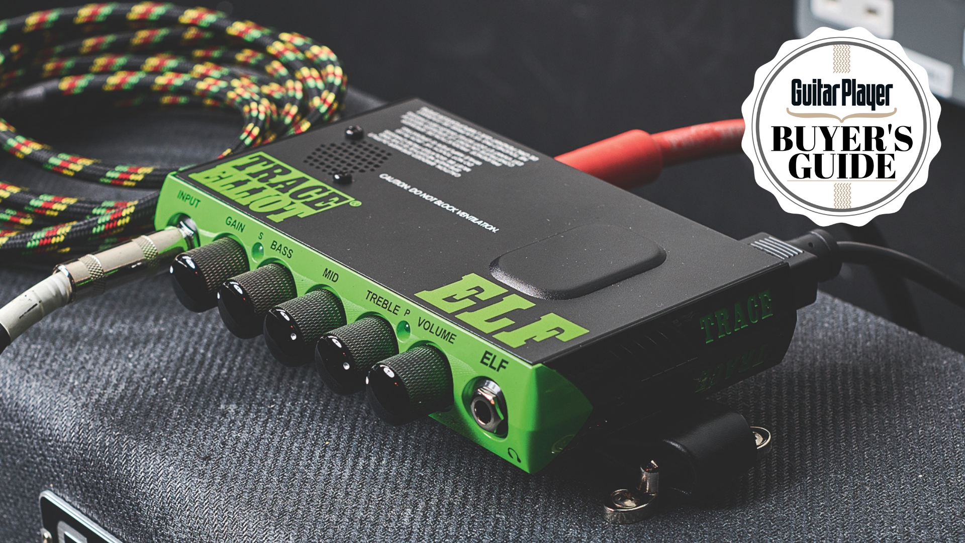 A Trace Elliot Elf bass amp head on top of a Fender Bassman with a guitar cable next to it