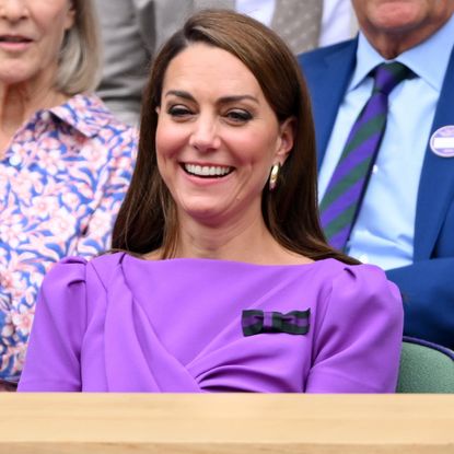 Catherine Princess of Wales laughing court-side of Centre Court during the men's final on day fourteen of the Wimbledon Tennis Championships at the All England Lawn Tennis and Croquet Club on July 14, 2024 in London, England.