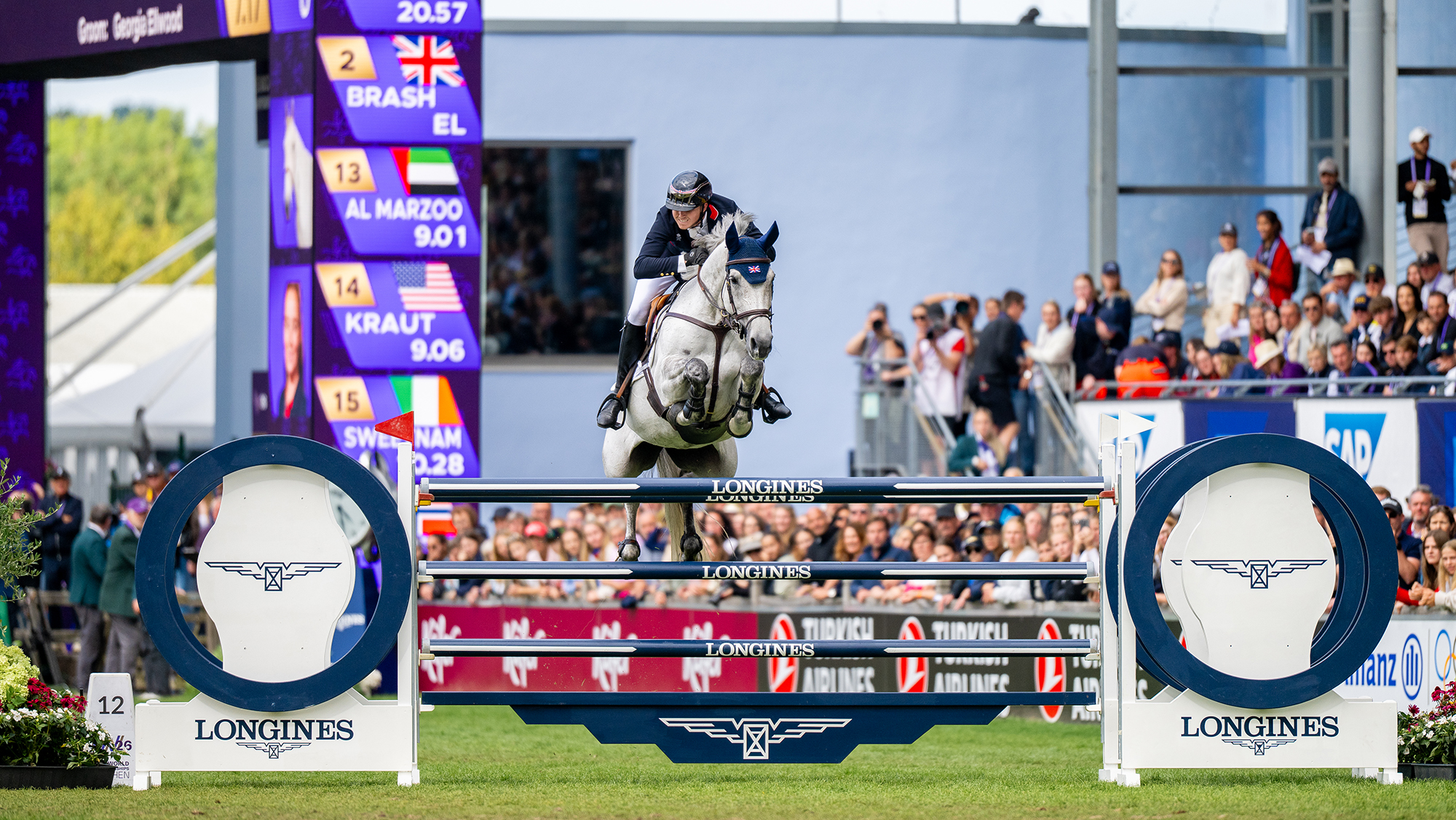 Harry Charles and LT Holst Freda, a grey horse, jump the final fence at the showjumping World Championships &amp;ndash; a blue fence with LONGINES written on the poles
