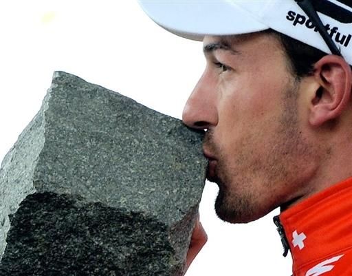 Fabian Cancellara (Saxo Bank) kisses his new cobblestone trophy.