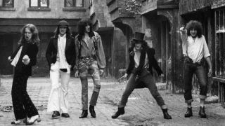 The Heavy Metal Kids posing for a photograph in a street in the early 1970s