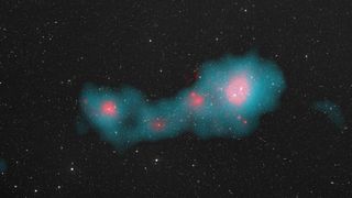 glowing pink galaxies are surrounded by an eerie blue light in the found in the Shapley supercluster