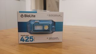 The Biolite HeadLamp 425 in its packaging placed on a wooden table