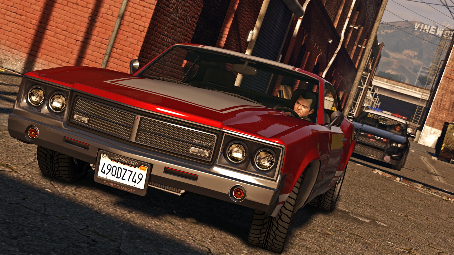 Michael drives a red muscle car from GTA 5