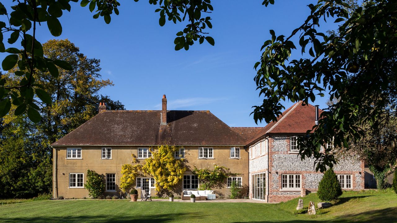 Exterior of 1920s country house with new wing in Wiltshire