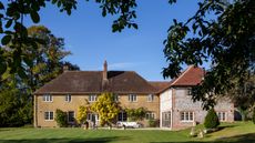 Exterior of 1920s country house with new wing in Wiltshire