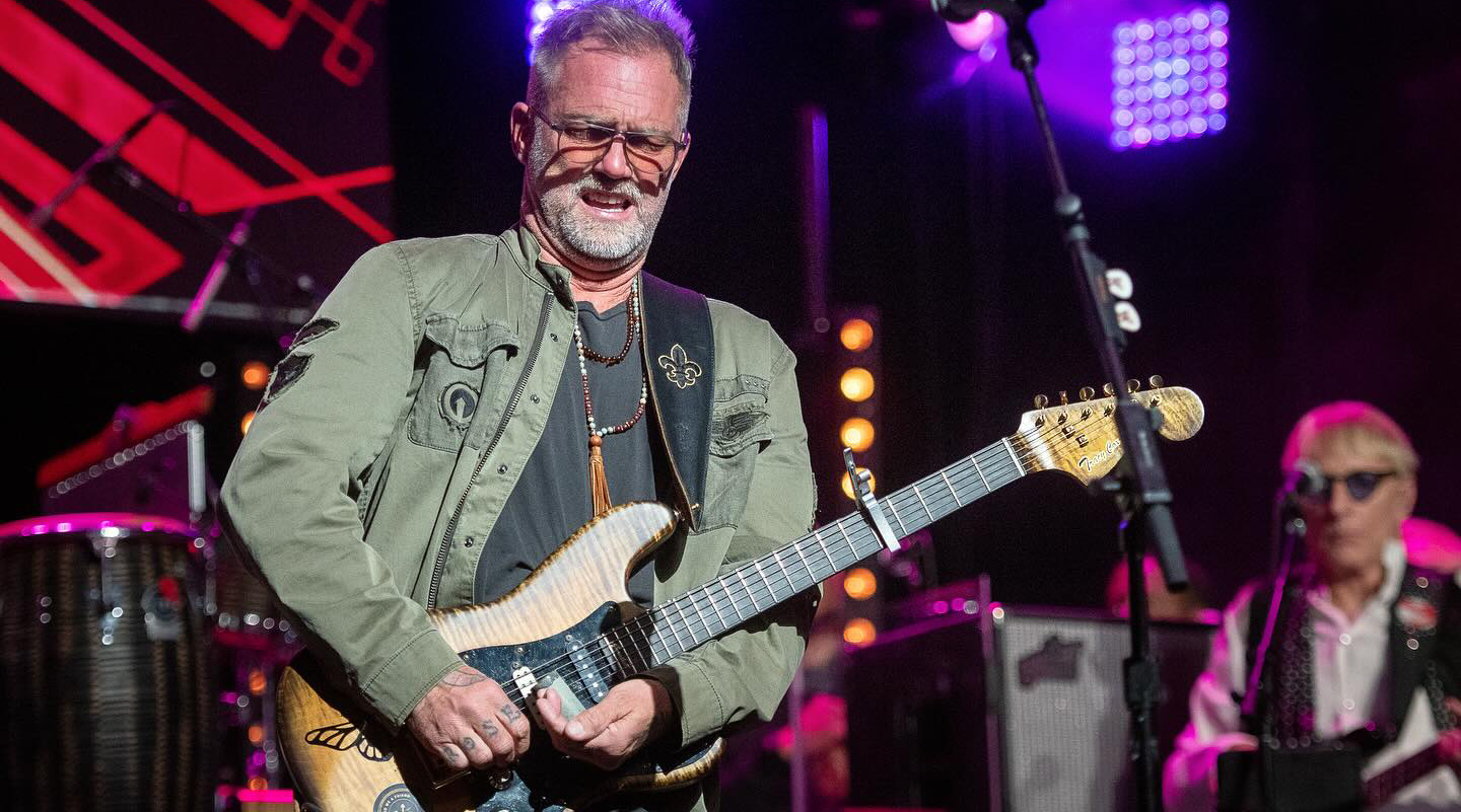 A photo of guitarist Anders Osborne performing with a Fender Stratocaster guitar