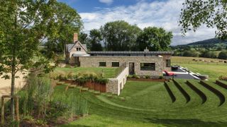 large lawned garden with landscaping around extension