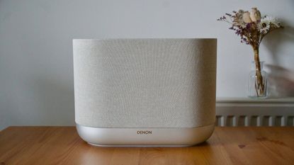 Denon Home 400 home speaker on a wooden surface