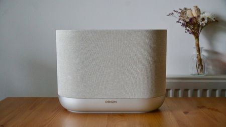 Denon Home 400 home speaker on a wooden surface