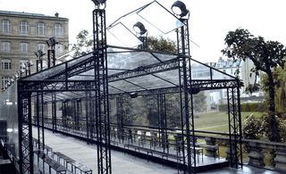 Minimal tent with panelled lighting, evocative of a Victorian greenhouse, in the romantic rose garden