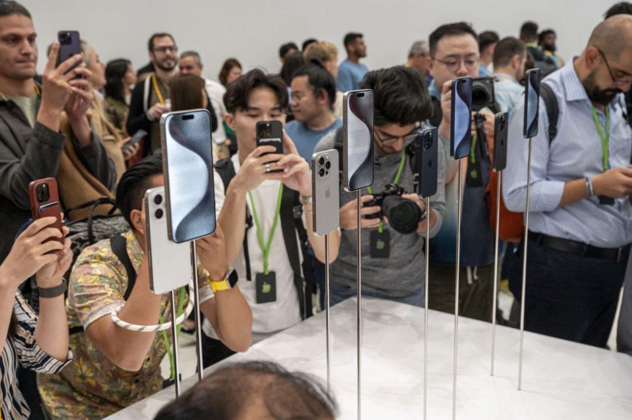 Spectators attend the new iPhone unveiling.