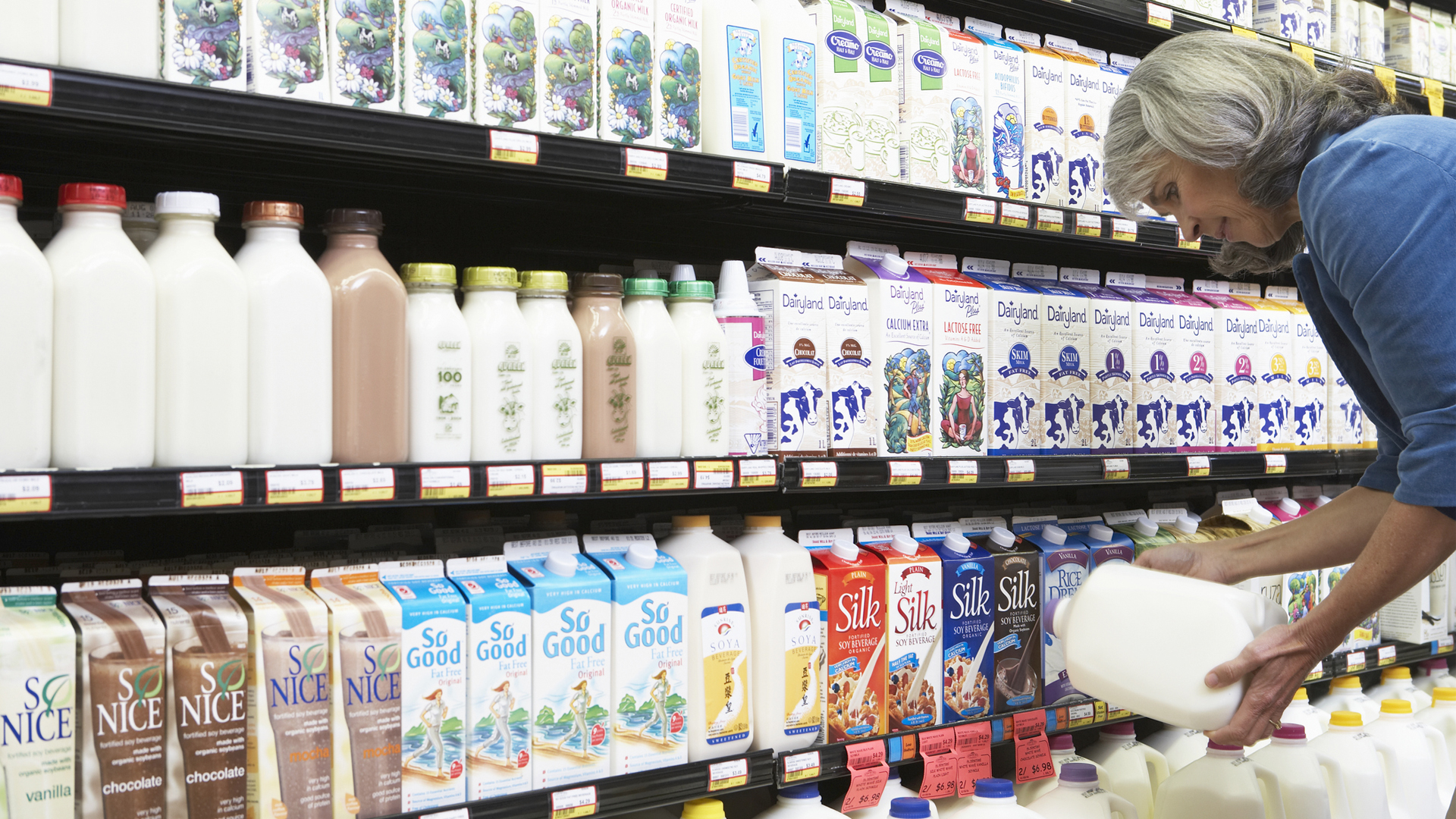 Woman buying milk in a supermarket