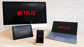 Netflix logo displayed on a TV, laptop, tablet, and smartphone