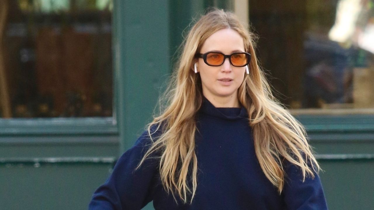 Jennifer Lawrence walks in Manhattan wearing a navy sweater and white skirt