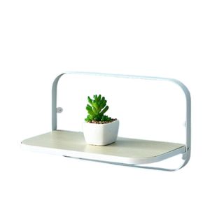 A wooden foldable shelf with a plant on it