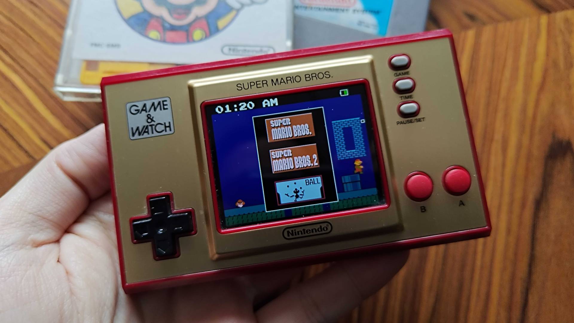Mario Game and Watch displaying game menu featuring Super Mario Bros, Super Mario Bros 2, and Ball.