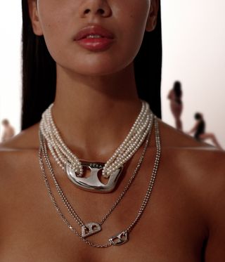 woman wearing pearl necklace and chains