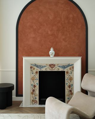 A fireplace with a mosaic surround