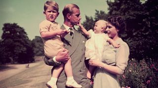 Prince Philip, Queen Elizabeth II and Princess Anne and Prince Charles as children in the gardens of Clarence House