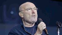 Phil Collins performing onstage in 2022