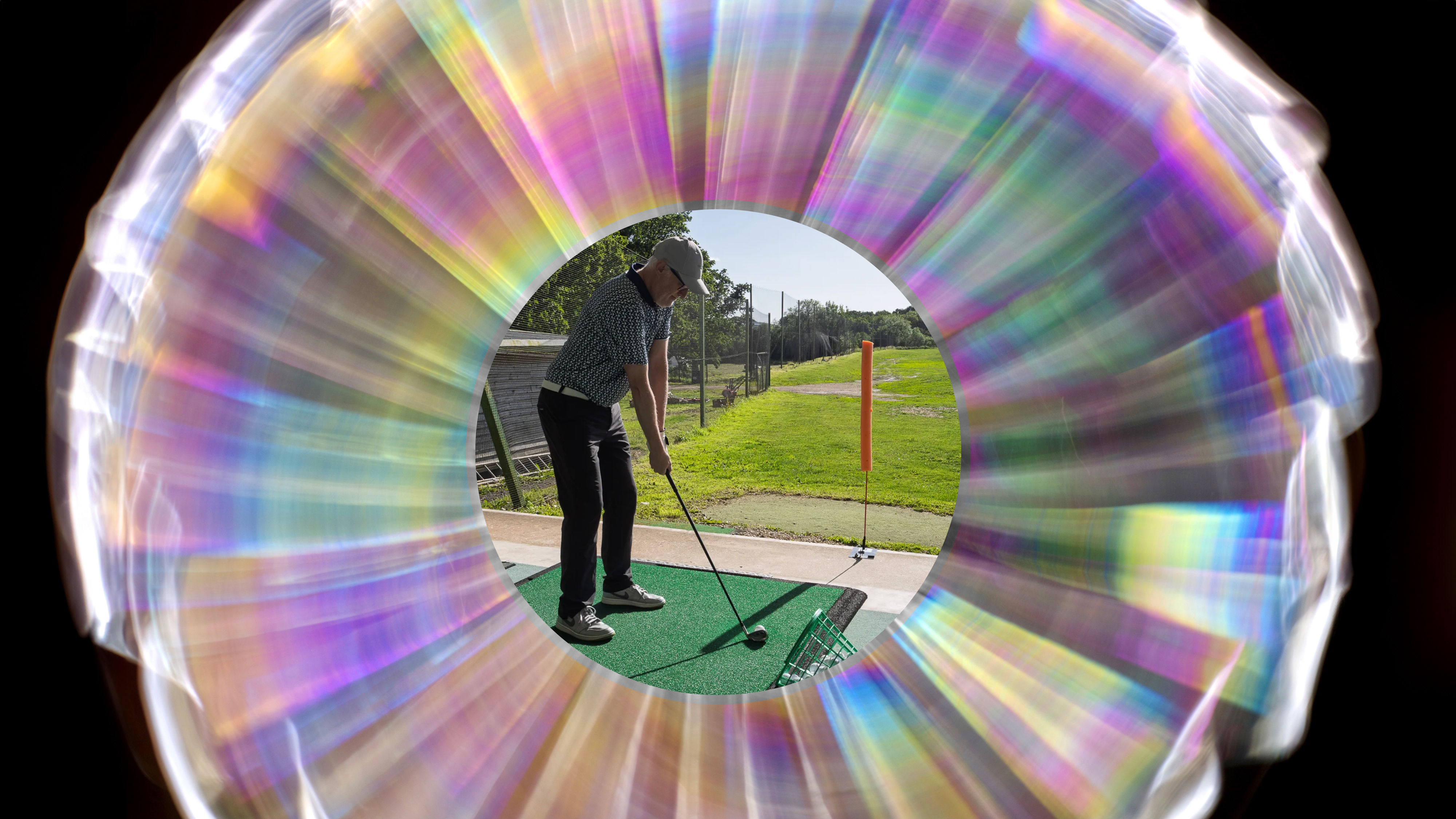 A giant holographic eye to represent the parallax paradox with the centre of the image being Rob Spedding preparing to hit a golf shot with correct alignment and training aids